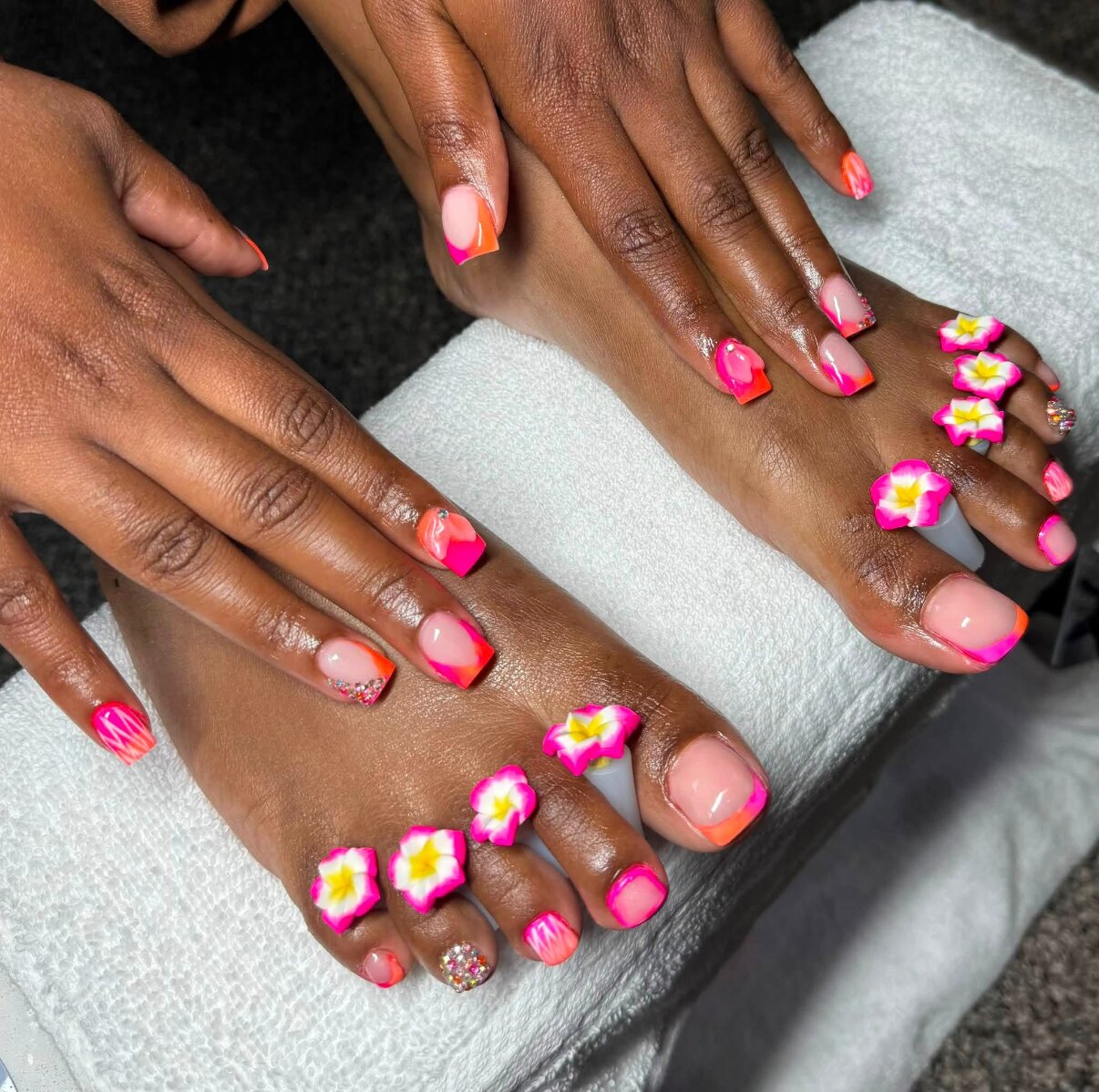 Matching pink 3D flower manicure and pedicure